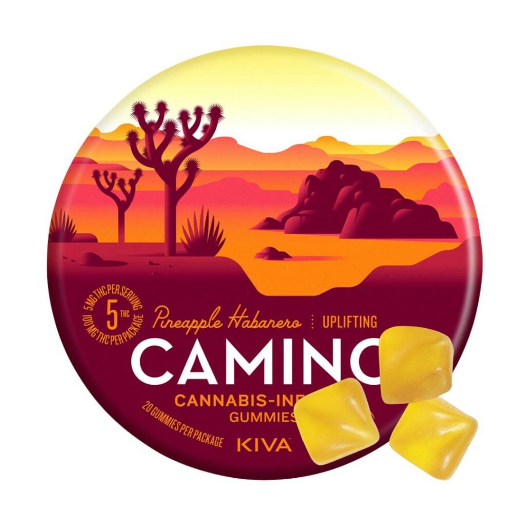 Round tin of Camino gummies in pineapple habanero flavor, featuring a desert sunrise design and three yellow gummies displayed in front.