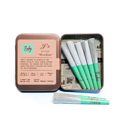 White Widown strain Open tin box with five pre-rolled joints inside and one joint outside, each with a green filter.