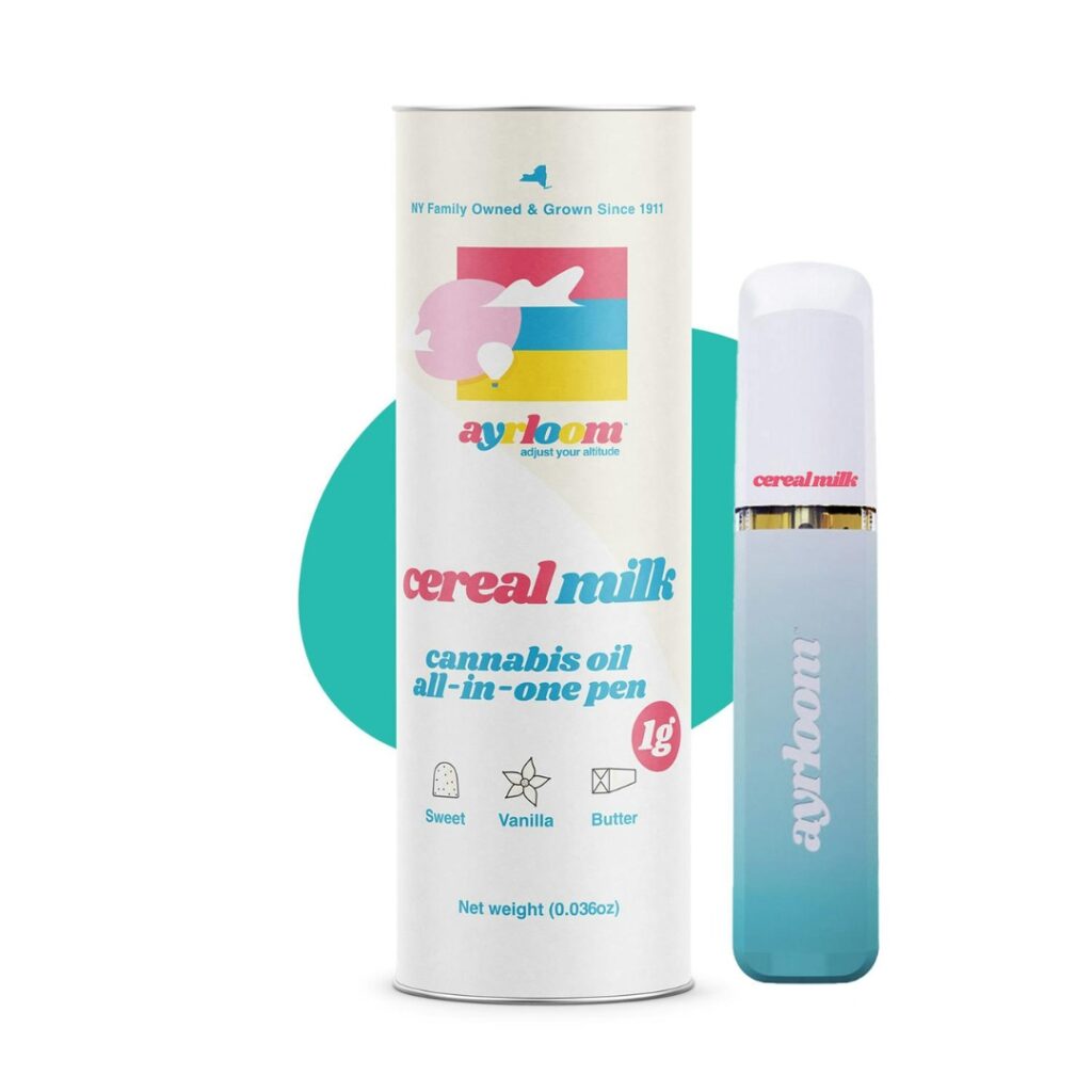 A cannabis oil vape pen labeled Cereal Milk strain sits beside its colorful, branded packaging.