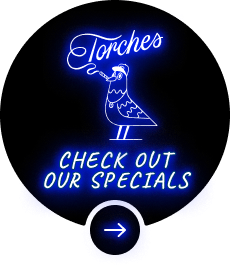 Neon sign with a bird smoking, text reads: Torches. Check out our specials with an arrow below.