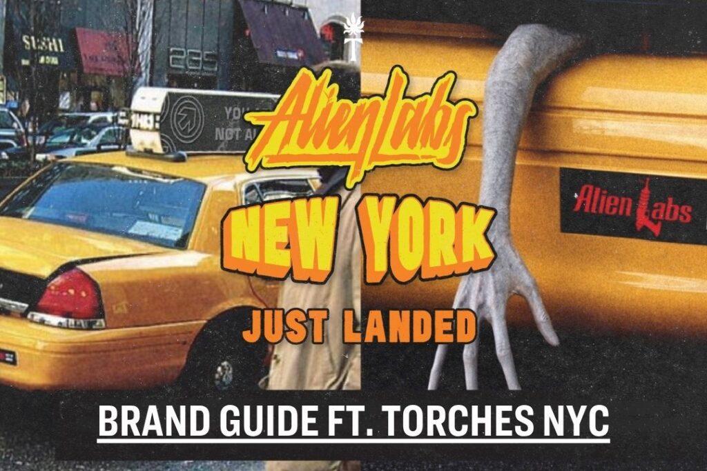 Yellow taxi with Alien Labs Brand New York Just Landed text and an alien hand reaching out; urban NYC background.