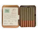A metal tin from Torches NYC holds six rolled pre-rolls with brown filters, next to an informational label inside the lid.